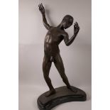 A bronze figurine of a nude athlete signed John, on a marble base, 25" high