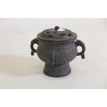 A bronze censer with archaic style decoration and pierced cover, 8" high
