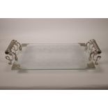 A glass serving tray with silvered metal mounts and handles, decorated in an Eastern style, 22½" x