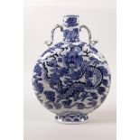 A Chinese blue and white porcelain two handled moon flask decorated with a dragon clutching the