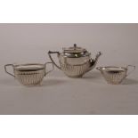 A novelty sterling silver miniature three piece tea set, largest 2"