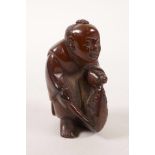 A Chinese faux horn carving of a fisherman, 2½" high