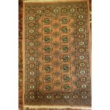 A salmon ground Bokhara pattern Eastern rug, 49" x 31"