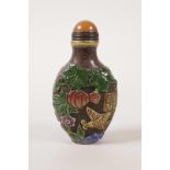A Peking glass snuff bottle with carved and enamelled bird and fruit decoration, 3" high