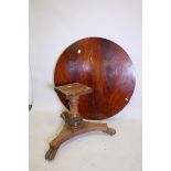 A C19th mahogany table top, 51" diameter, and a carved platform base