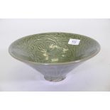 A Cizhou style bowl, with green glaze and scrolling floral decoration, 10" diameter