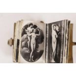 A brass bound miniature book containing photographs of female nudes taken from classical