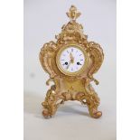 A C19th Rococo style mantel clock with gilt composition decoration applied to a pewter/zinc case,