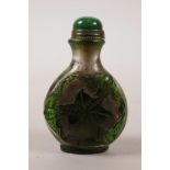 A Peking glass snuff bottle with carved bat and flower decoration, 3" high