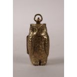 A brass sovereign case in the form of an owl, 2½"