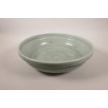 A large Chinese celadon crackle glazed pottery bowl with underglaze floral decoration, 14½" diameter