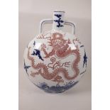 A Chinese porcelain moon flask decorated with a red fiery dragon amongst blue clouds, blue seal mark