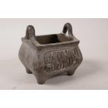 An Eastern bronze censer with two handles and Islamic calligraphic script to side, impressed mark to