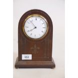 A mahogany and brass inlaid mantel clock with fleur de lys decoration, the enamel dial with Roman