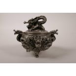 A Chinese silvered metal censer on tripod feet, with two handles and all over dragon decoration,