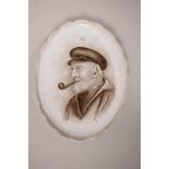 A porcelain plaque hand painted with a portrait of a bearded sailor with his pipe, signed PJH, 7"