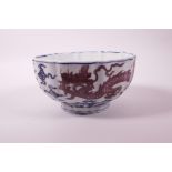 A Chinese blue and white porcelain bowl with lobed rim and red dragon decoration, 6 character mark