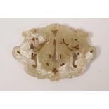 A Chinese carved and pierced jade pendant with twin dragon decoration, 3" wide