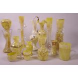 A collection of decorative yellow glass vases, many with enamelled decoration in the Beykoz
