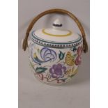 A Poole pottery biscuit barrel with basket handle, 6" high