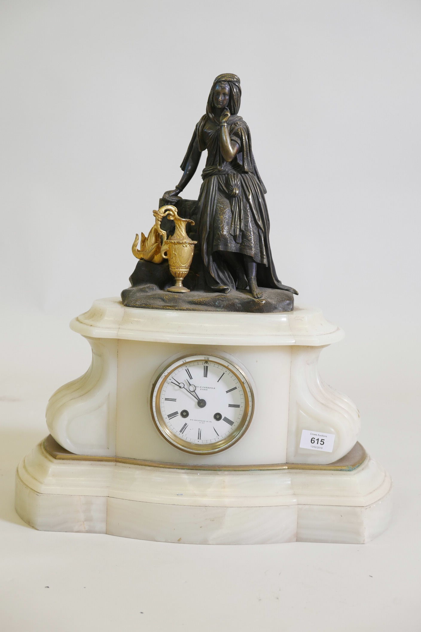 A C19th French onyx mantel clock, with a bronze and ormolu figure of an Ottoman woman with ewer, the