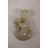 A Chinese celadon jade pendant carved in the form of a figure riding a duck, 2" high