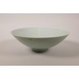 A Chinese celadon glazed porcelain dish with incised floral and figural decoration to bowl, 8"