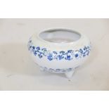 A Chinese ceramic fish bowl, with blue and white decoration of young boys, raised on tripod
