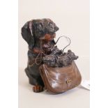 A cold painted bronze inkwell in the form of a dachshund with a satchel of puppies, 4½" high