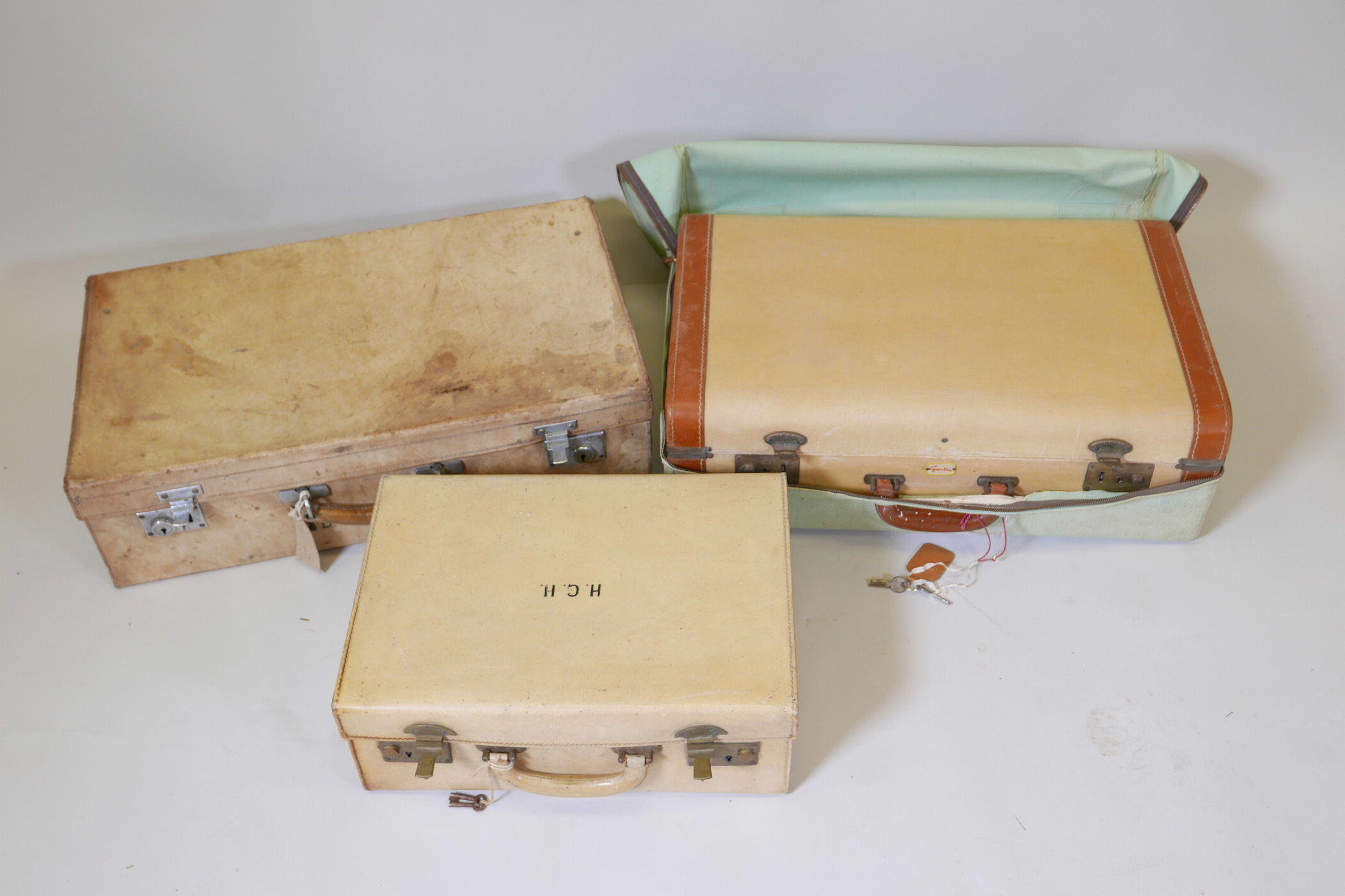 A Finnigans pigskin suitcase with hallmarked silver topped vanity bottles, 23" x 14" x 6½", together