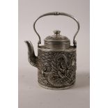 A Chinese silvered metal teapot with raised decoration of a dragon chasing the flaming pearl,