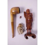 An Oriental carved horn figure of a sage on a carved wood base, 5½" high, A/F, together with a