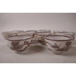 Three early Chinese porcelain tea bowls decorated with a phoenix/dragon flying amongst clouds with 4