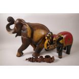 Two carved wood figurines of elephants, largest 13" high, together with a carved hardwood pipe