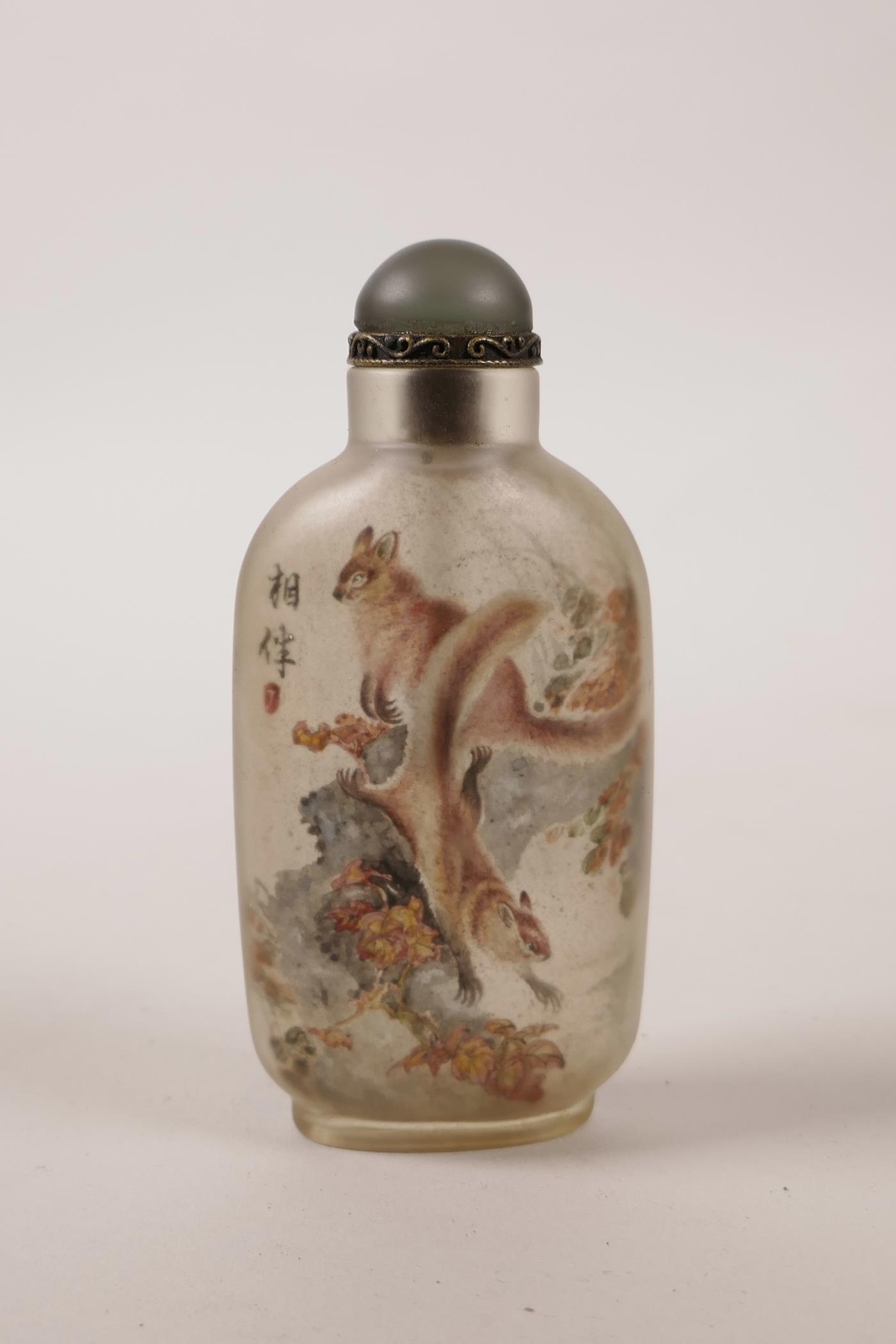 A Chinese reverse painted glass snuff bottle decorated with squirrels, inscription verso, 4" high