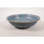 A Chinese blue ground pottery bowl with chased and gilt character inscription decoration, incised