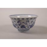 A Chinese blue and white porcelain tea bowl with scrolling floral decoration, 3½" diameter