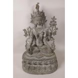 A Tibetan bronze figurine of a female deity seated in meditation, 15" high