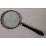 A large hand held magnifying glass with turned wood handle, 11½" long