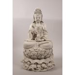 A large Chinese blanc de chine Quan Yin seated on a lotus throne, impressed seal marks verso, 16"