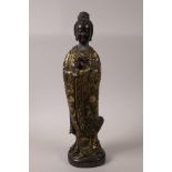 A Chinese bronze Quan Yin holding a dragon, with red patination and giltwashed decoration, 16"