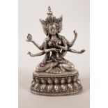 A Sino-Tibetan silvered metal deity with three heads and many arms, impressed double vajra mark to