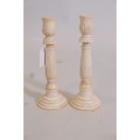 A pair of carved bone candlesticks, 8" high