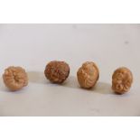 Four Oriental carved nuts, two as netsuke, 1¼" diameter