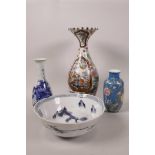 An Oriental porcelain baluster vase with narrow neck and flared rim, painted with fruit, flowers and