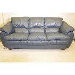 A blue leather three seater sofa, 84" wide