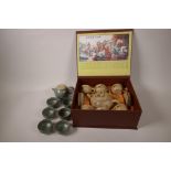 A boxed Chinese stoneware tea set of teapot and six cups and saucers painted with flowers,