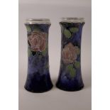 A pair of Royal Doulton cylinder vases with Art Nouveau rose decoration, signed to bases, 10½" high