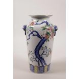 A Chinese polychrome porcelain vase with two mask handles, decorated with a pomegranate tree in
