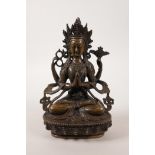 A Sino-Tibetan bronze deity seated on a lotus throne, 8½ diameter